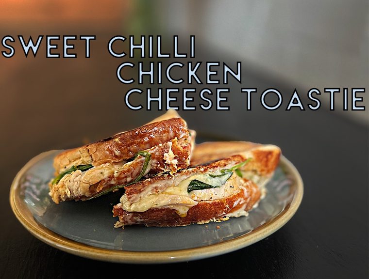 A tall skewered sourdough sandwich with seasoned fries